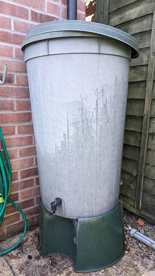 Outdoor rainwater storage tub with a lid to prevent debris and insects